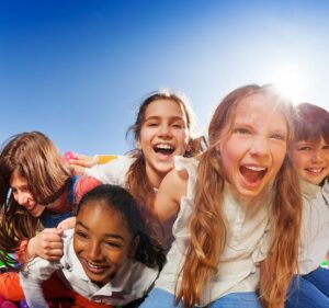 children joyfully playing field sports on a sunny day