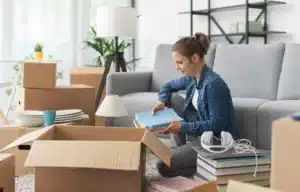A woman packs cardboard boxes for an upcoming move