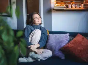 A woman relaxes on the couch to enjoy a moment of serenity