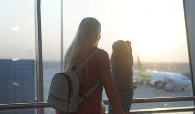 Military mom with child at an airport for a PCS overseas.