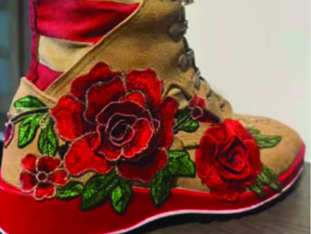Military boots with hand-painted roses and american flag