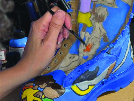 Progression of hand painted combabt boots in an urban street style