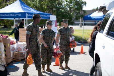 Military service members volunteering at an ASYMCA food distribution event