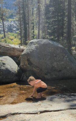 Military kid playing in the stream at Sequoia National Park before a PCS.
