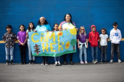 Military kids hold a banner for ASYMCA Operation Camp