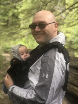 Military service member and his newborn during a military family hike at Mt. Rainier