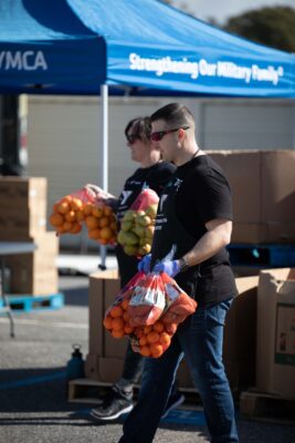 ASYMCA Volunteer carrying fresh produce to military families