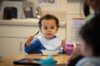 Military child eating at ASYMCA's Operation Little Learners class