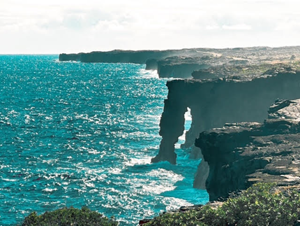 natural arch formation the extends from a cliff to the sea on the coastline of Hawaii