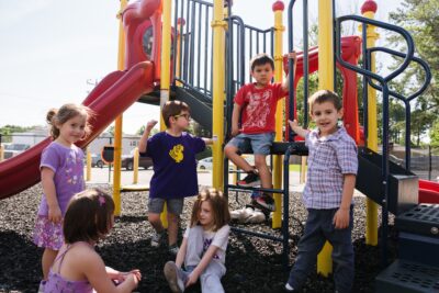 Military kids playing together at an ASYMCA playground