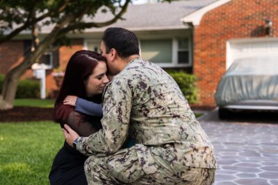 Military family hugging each other to show reunions through ASYMCA Operation Ride Home