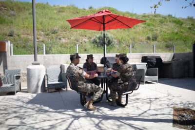 Military service members sitting together outside an ASYMCA branch
