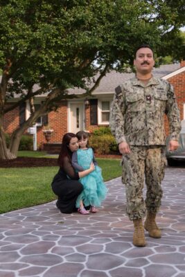 Military service member leaving his family for deployment