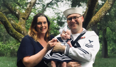 Military spouse writer Julianna smiles with her service member and daughter for Military Family Appreciation Month