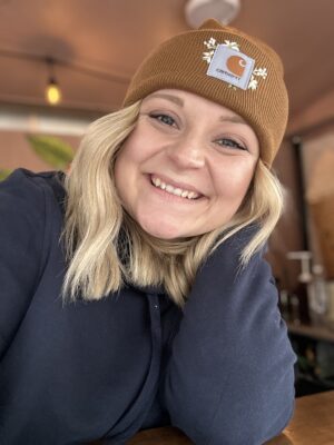 ASYMCA Military spouse writer Maddison wears a big smile on her face