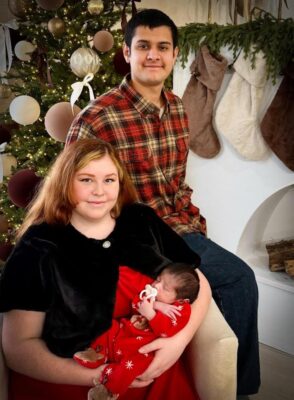 First time military parents with their newborn son at Christmas time. 