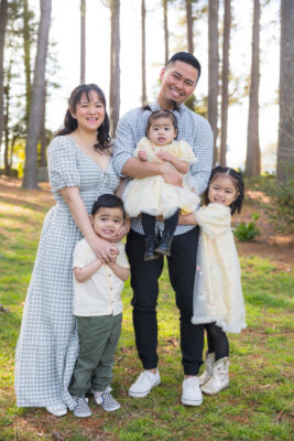 Mary Joy Matias, a military spouse, posing with her husband and three young children.