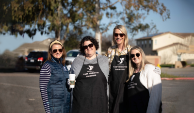 Four women posing while volunteering at Camp Pendleton on a sunny day.