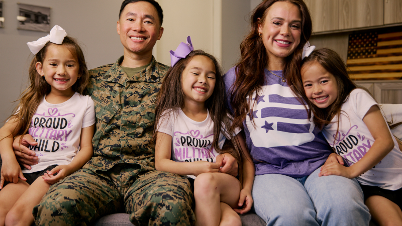 A junior enlisted Marine with his spouse and three daughters